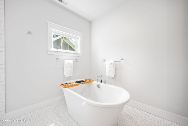 215 W Foster Ave, Coeur Dalene, ID 83814 - bathroom featuring a freestanding tub, baseboards, and tile patterned floors