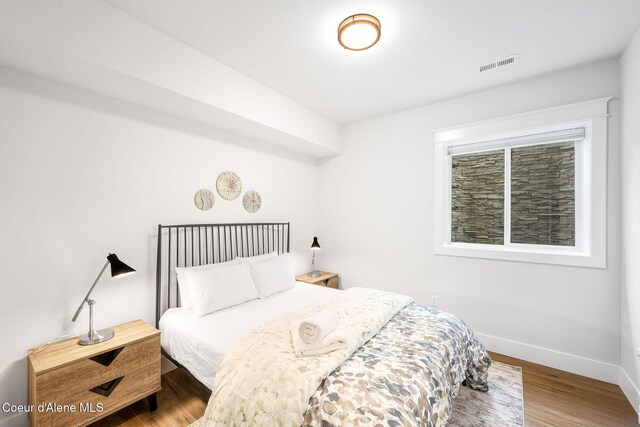 215 W Foster Ave, Coeur Dalene, ID 83814 - bedroom featuring baseboards and wood finished floors