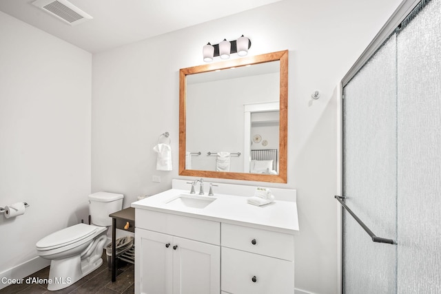 215 W Foster Ave, Coeur Dalene, ID 83814 - full bathroom with toilet, vanity, an enclosed shower, and baseboards