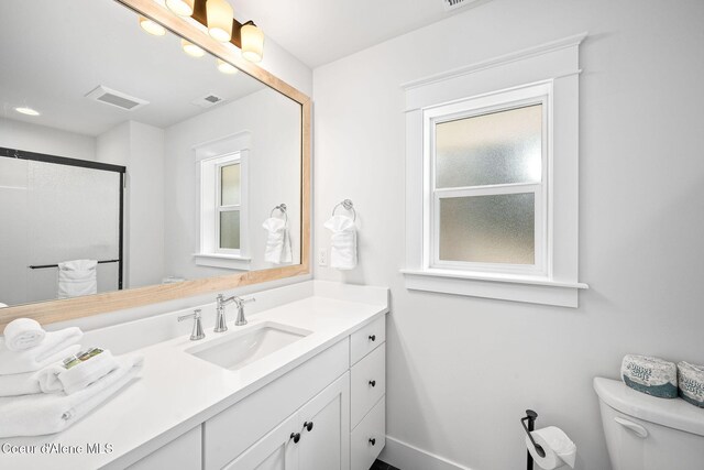 215 W Foster Ave, Coeur Dalene, ID 83814 - full bathroom featuring toilet, vanity, a shower with door, and baseboards
