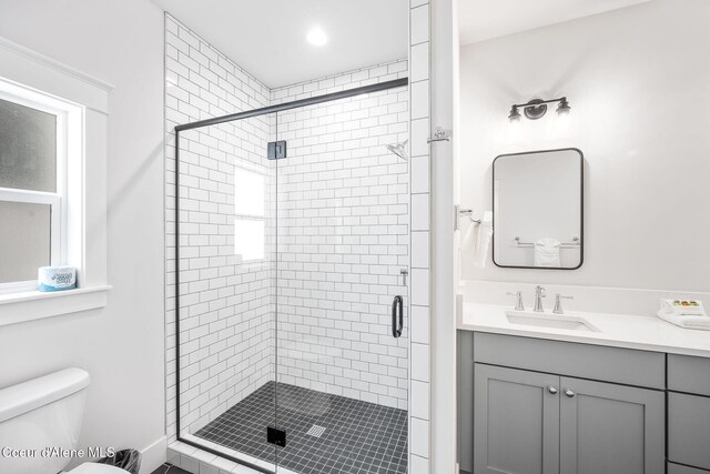215 W Foster Ave, Coeur Dalene, ID 83814 - bathroom with a shower stall, vanity, and toilet