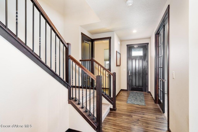 4631 E Alopex Ln, Post Falls, ID 83854 - entryway with wood finished floors, stairway, baseboards, and a textured ceiling