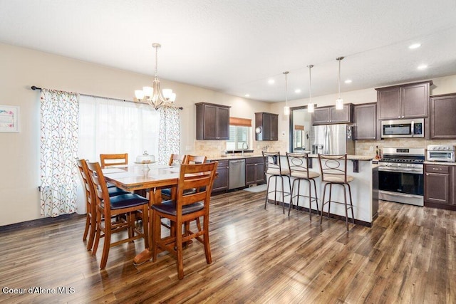 4631 E Alopex Ln, Post Falls, ID 83854 - dining space featuring a chandelier, dark wood-style flooring, and recessed lighting