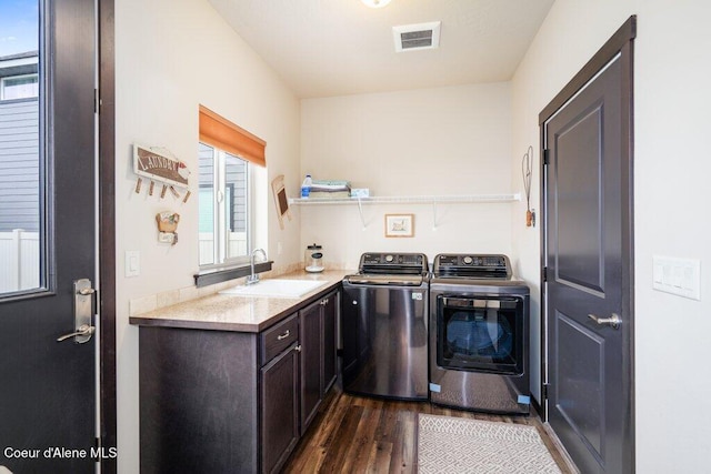 4631 E Alopex Ln, Post Falls, ID 83854 - laundry room featuring dark wood finished floors, washer and clothes dryer, and cabinet space