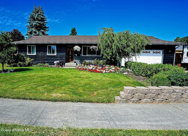 single story home with a garage and a front lawn