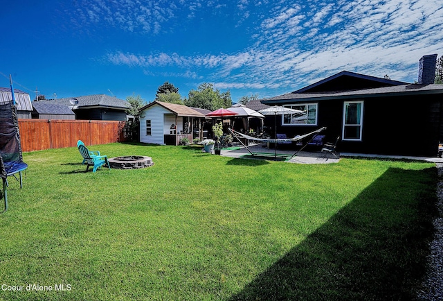 view of yard featuring a fire pit and a patio area