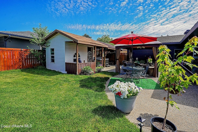 rear view of property featuring a patio area and a gazebo