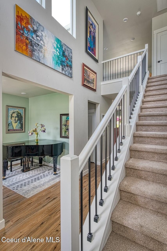 511 University Park Way, Sandpoint, ID 83864 - staircase with wood finished floors, a high ceiling, and baseboards