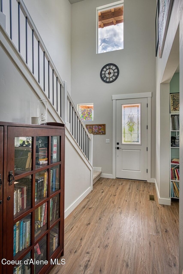 511 University Park Way, Sandpoint, ID 83864 - foyer entrance with a towering ceiling, baseboards, stairway, and wood finished floors
