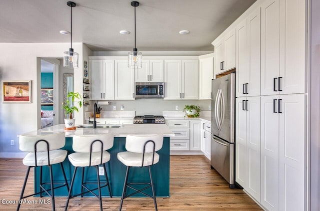 511 University Park Way, Sandpoint, ID 83864 - kitchen with appliances with stainless steel finishes, a sink, white cabinets, and light countertops