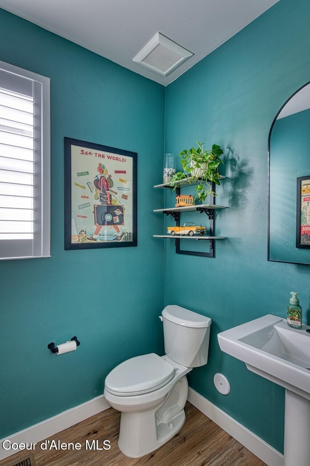 511 University Park Way, Sandpoint, ID 83864 - half bathroom featuring wood finished floors, toilet, and baseboards