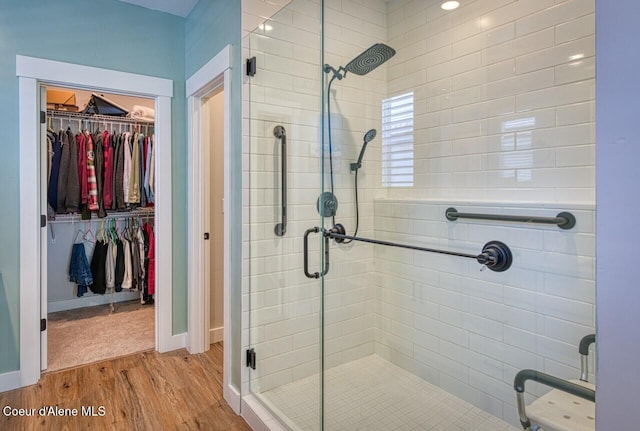 511 University Park Way, Sandpoint, ID 83864 - full bath featuring a shower stall, wood finished floors, a walk in closet, and baseboards