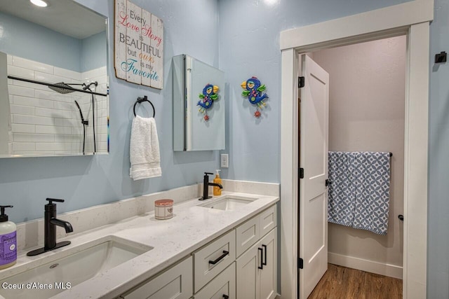511 University Park Way, Sandpoint, ID 83864 - full bathroom featuring double vanity, wood finished floors, and tiled shower