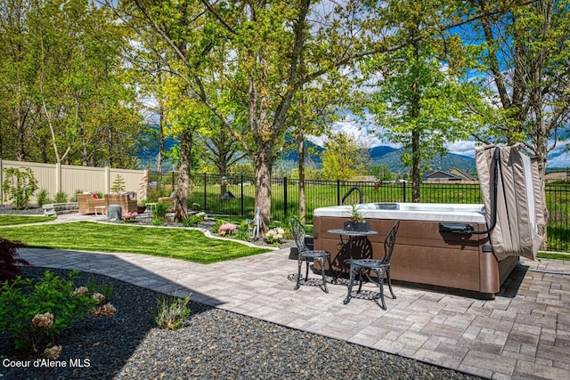 511 University Park Way, Sandpoint, ID 83864 - view of patio with a hot tub, a mountain view, and outdoor lounge area