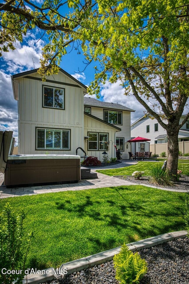 511 University Park Way, Sandpoint, ID 83864 - rear view of property with board and batten siding and a patio