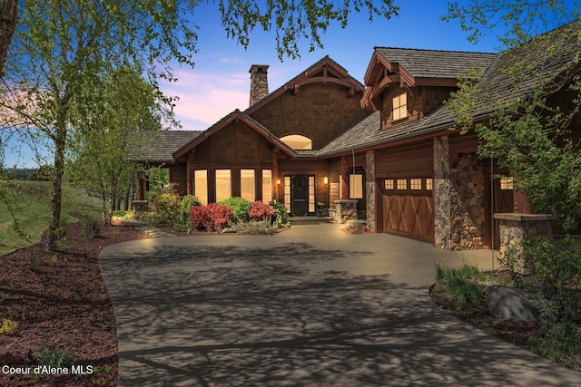 16829 S Lazurite Dr, Coeur Dalene, ID 83814 - view of front of home featuring driveway, an attached garage, a chimney, and stone siding