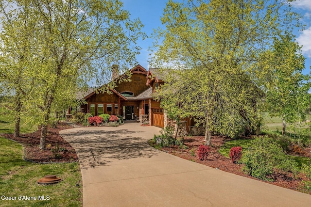 16829 S Lazurite Dr, Coeur Dalene, ID 83814 - view of front of home featuring concrete driveway, a chimney, an attached garage, and stone siding