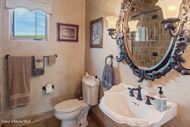 16829 S Lazurite Dr, Coeur Dalene, ID 83814 - bathroom featuring a sink, toilet, baseboards, and a tile shower