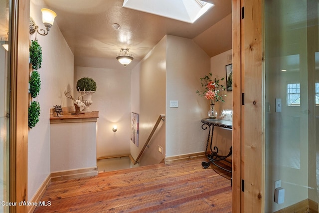 16829 S Lazurite Dr, Coeur Dalene, ID 83814 - corridor featuring hardwood / wood-style flooring, a skylight, an upstairs landing, and baseboards