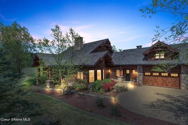 16829 S Lazurite Dr, Coeur Dalene, ID 83814 - view of front of house with driveway, stone siding, and a chimney