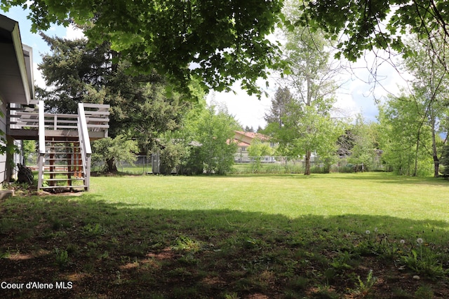 view of yard featuring stairs and a wooden deck