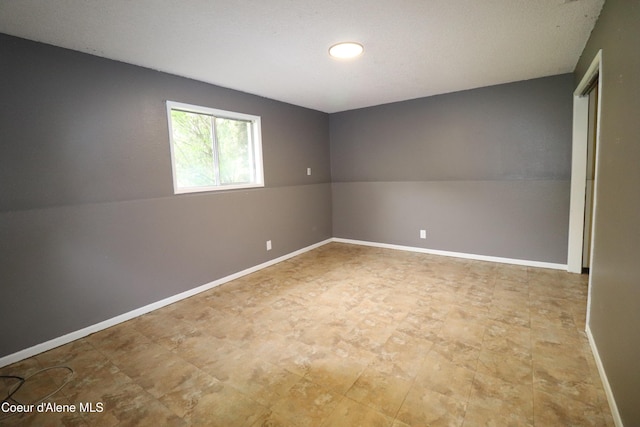 empty room featuring baseboards