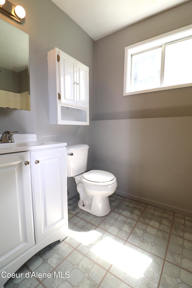 bathroom featuring toilet and vanity