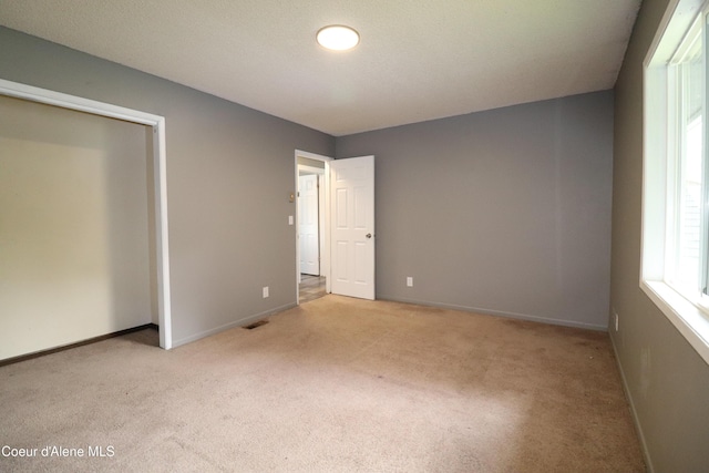 unfurnished bedroom with carpet floors and baseboards