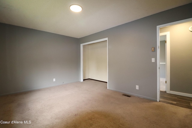 unfurnished room featuring carpet flooring and baseboards