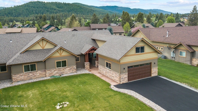 24 Bellflower Ct, Blanchard, ID 83804 - craftsman-style house featuring stone siding, a mountain view, roof with shingles, driveway, and a front yard