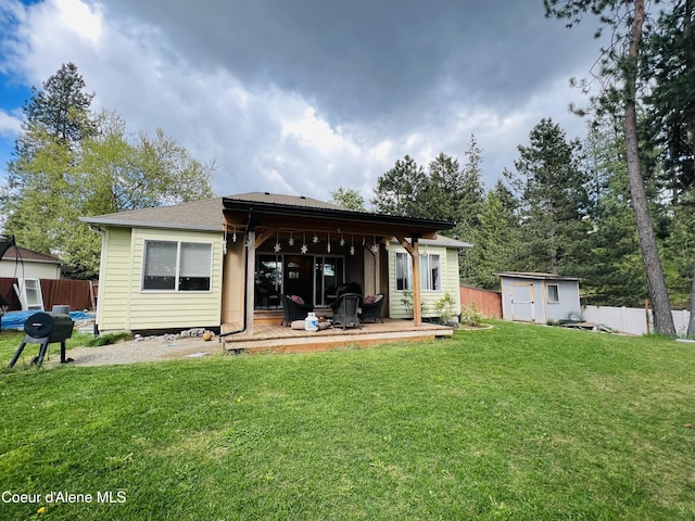 8351 N Audubon Dr, Hayden, ID 83835 - back of house with a shed, an outbuilding, and a deck