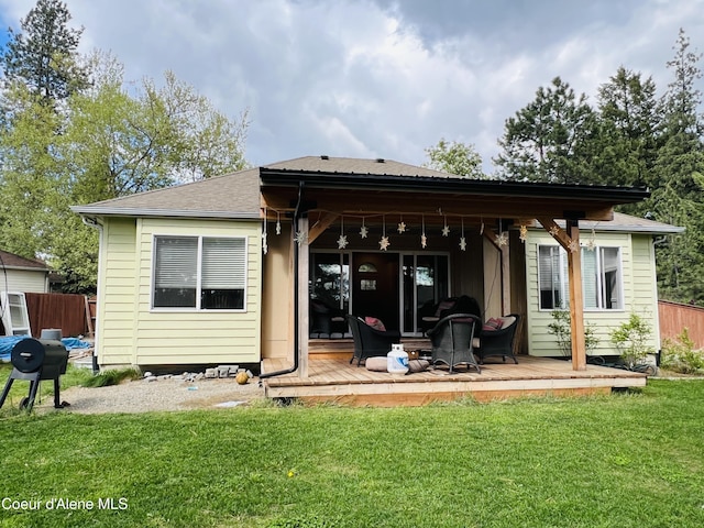 8351 N Audubon Dr, Hayden, ID 83835 - back of property featuring a wooden deck and a shingled roof