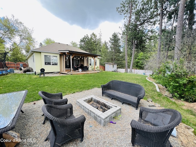 8351 N Audubon Dr, Hayden, ID 83835 - back of property with a storage shed, a fire pit, an outbuilding, and a patio area