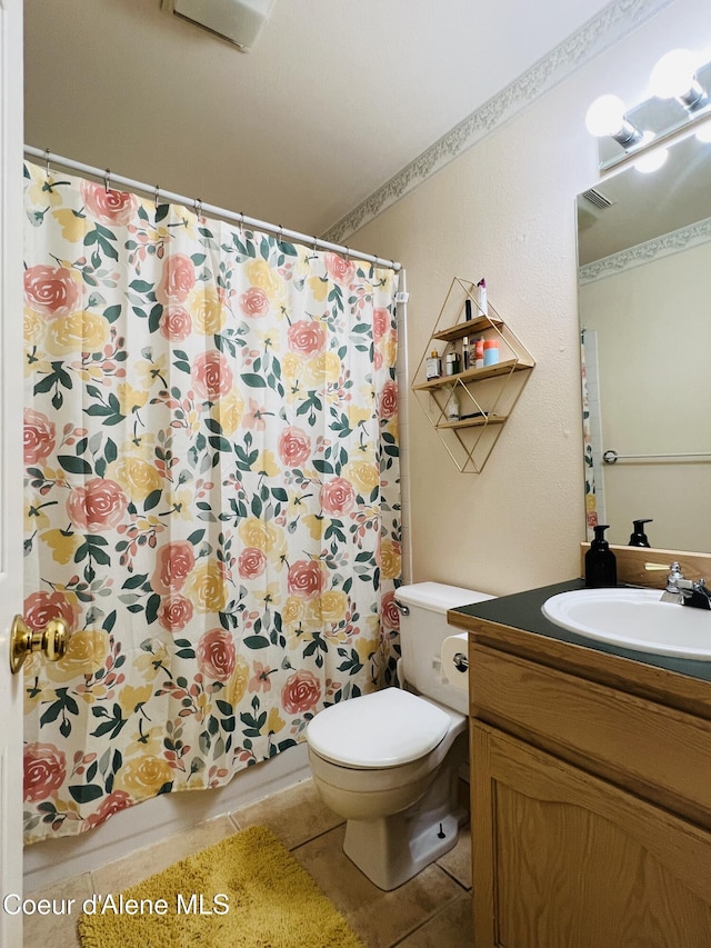 8351 N Audubon Dr, Hayden, ID 83835 - full bath featuring tile patterned floors, toilet, and vanity