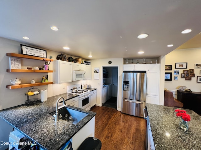 8351 N Audubon Dr, Hayden, ID 83835 - kitchen with white appliances, a sink, white cabinets, dark wood-type flooring, and recessed lighting