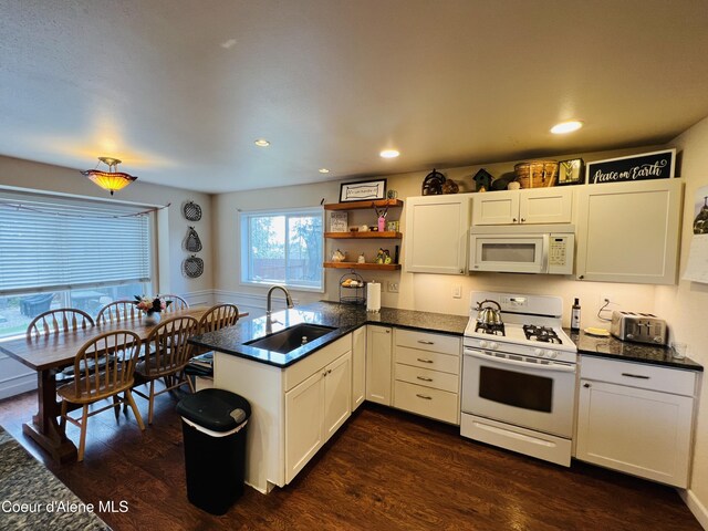 8351 N Audubon Dr, Hayden, ID 83835 - kitchen featuring white appliances, a sink, dark wood-style flooring, a peninsula, and recessed lighting