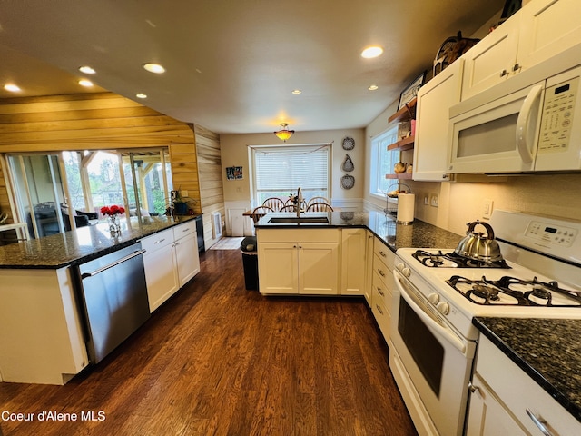 8351 N Audubon Dr, Hayden, ID 83835 - kitchen with white appliances, a peninsula, dark wood finished floors, recessed lighting, and white cabinets