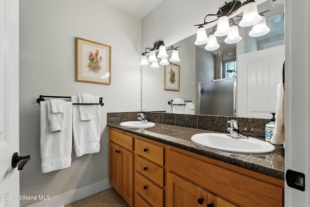 500 Guthrie Pl Unit 1303, Dover, ID 83825 - bathroom featuring a stall shower, double vanity, tile patterned floors, a chandelier, and baseboards