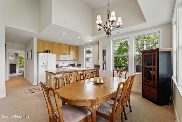 500 Guthrie Pl Unit 1303, Dover, ID 83825 - dining space featuring light carpet, a chandelier, baseboards, recessed lighting, and a high ceiling