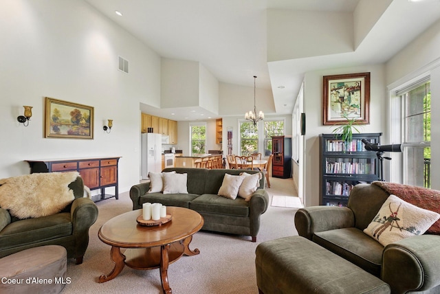 500 Guthrie Pl Unit 1303, Dover, ID 83825 - living area featuring light carpet, a chandelier, a high ceiling, and recessed lighting