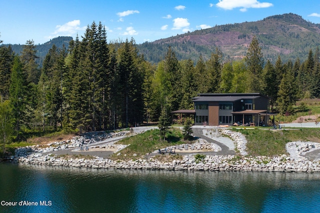 55 S Thistle Down Ln, Laclede, ID 83841 - back of house featuring a wooded view and a water and mountain view