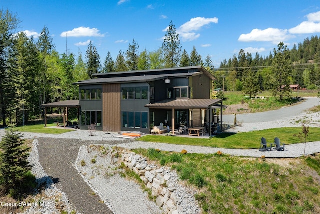 55 S Thistle Down Ln, Laclede, ID 83841 - rear view of property with a patio, a standing seam roof, metal roof, and a yard