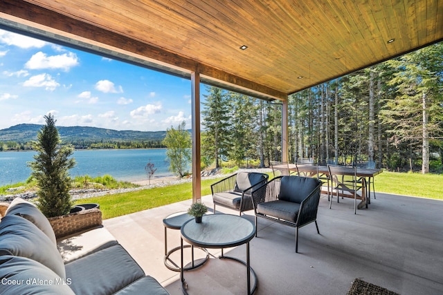 55 S Thistle Down Ln, Laclede, ID 83841 - view of patio / terrace with a water view, an outdoor hangout area, and outdoor dining space