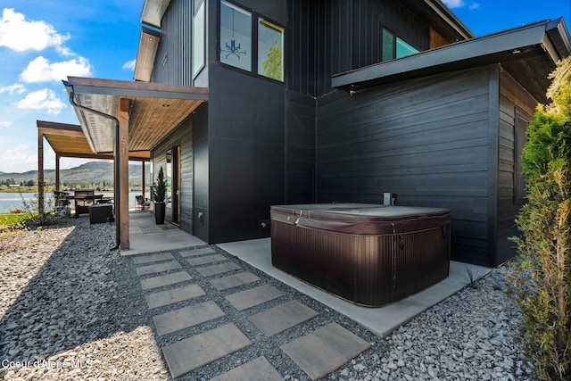 55 S Thistle Down Ln, Laclede, ID 83841 - view of patio / terrace featuring a hot tub and a water and mountain view