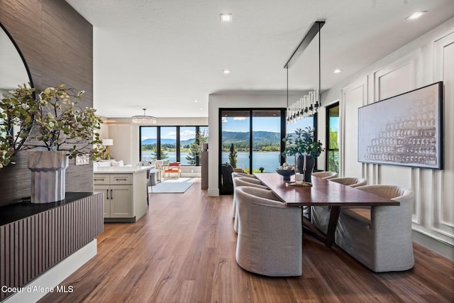 55 S Thistle Down Ln, Laclede, ID 83841 - dining area featuring wood finished floors, recessed lighting, and a water view