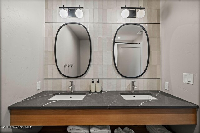 55 S Thistle Down Ln, Laclede, ID 83841 - full bath with double vanity, decorative backsplash, and a textured wall
