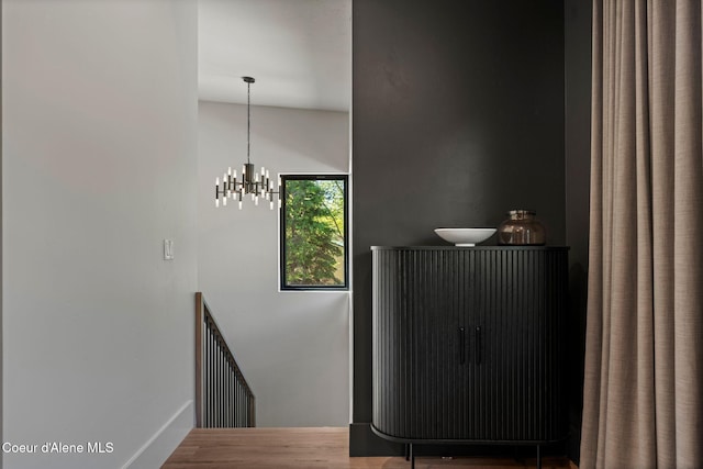 55 S Thistle Down Ln, Laclede, ID 83841 - staircase with wood finished floors, a chandelier, and baseboards