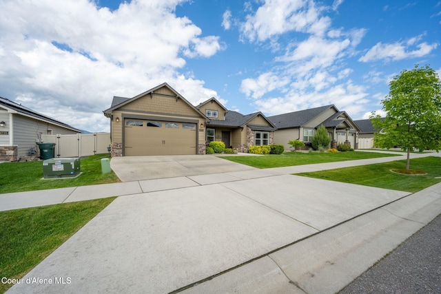 craftsman-style house featuring stone siding, concrete driveway, an attached garage, and a gate