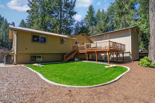 back of house featuring stairway, a wooden deck, a lawn, metal roof, and central AC unit