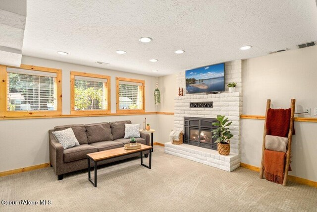 living room with carpet, recessed lighting, a textured ceiling, baseboards, and a fireplace